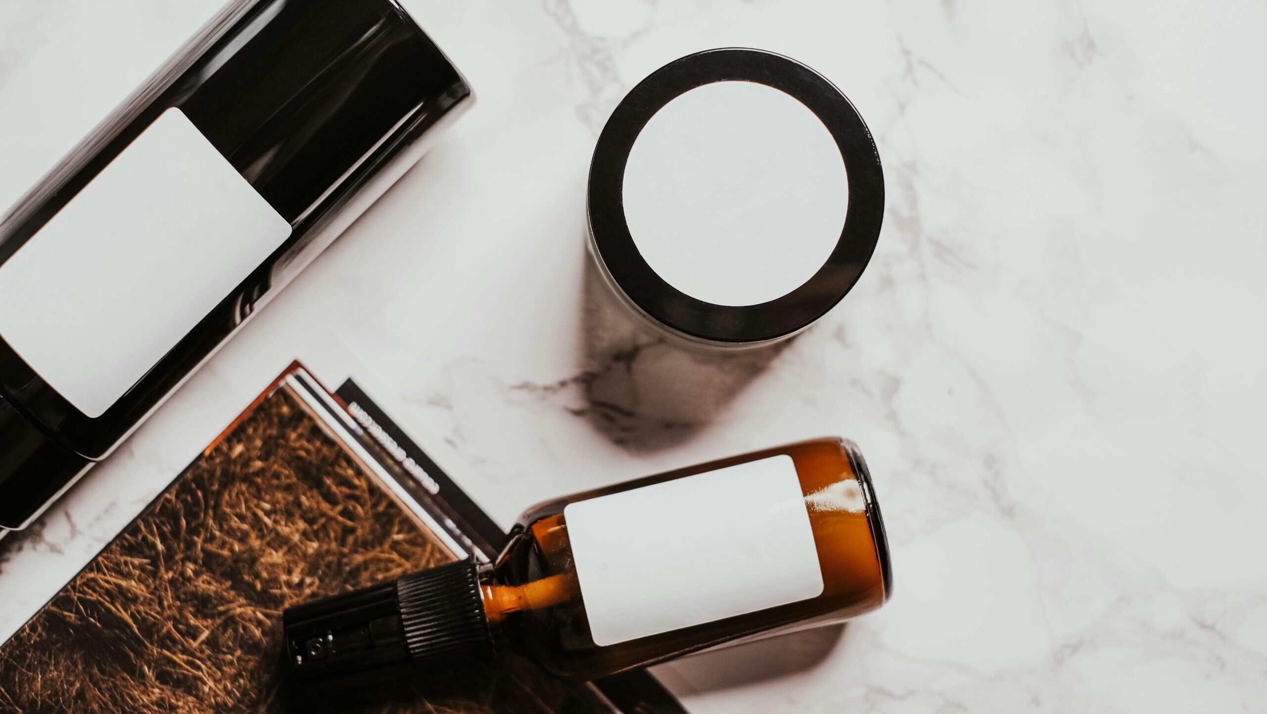 Beauty product bottles on marble surface