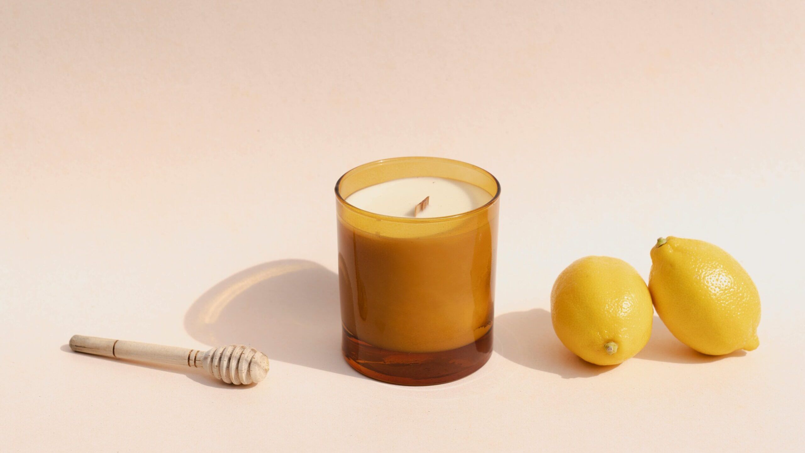 candle next to lemons, representing wellness habits for glowing skin
