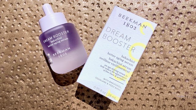 A purple dropper bottle laid out next to a white packaging box— showcasing beginner's guide to retinoids.