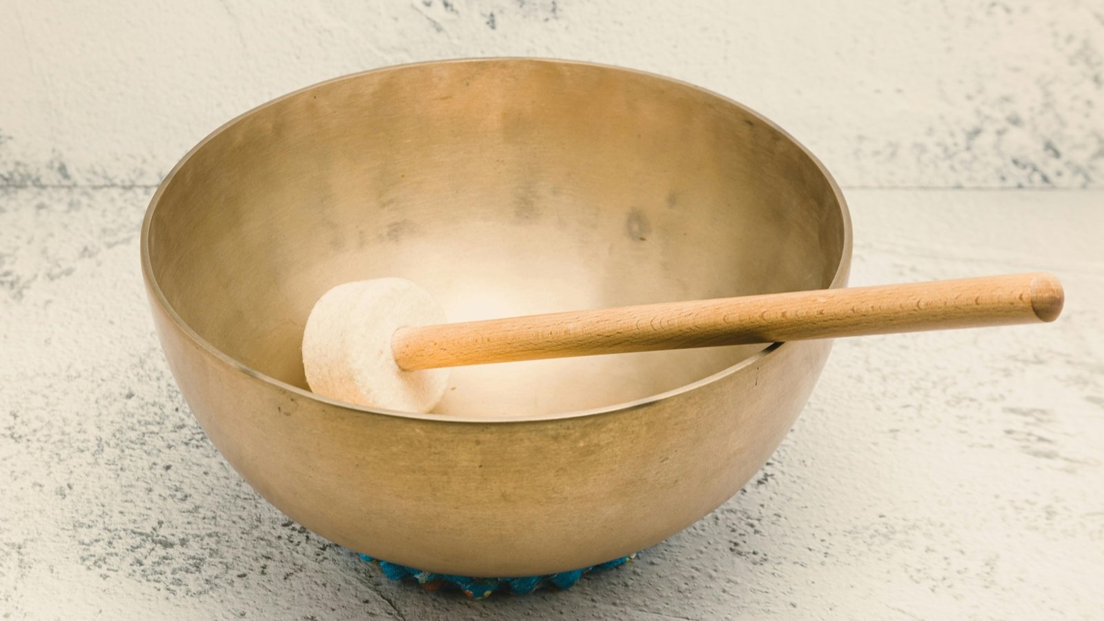 Close-up of a golden sound bowl, symbolizing wellness tools for mood and energy