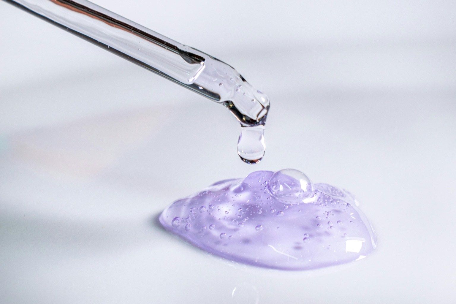 Clear dropper dispensing a lilac gel texture — a visual cue for must-have hydrators that layer like a dream.