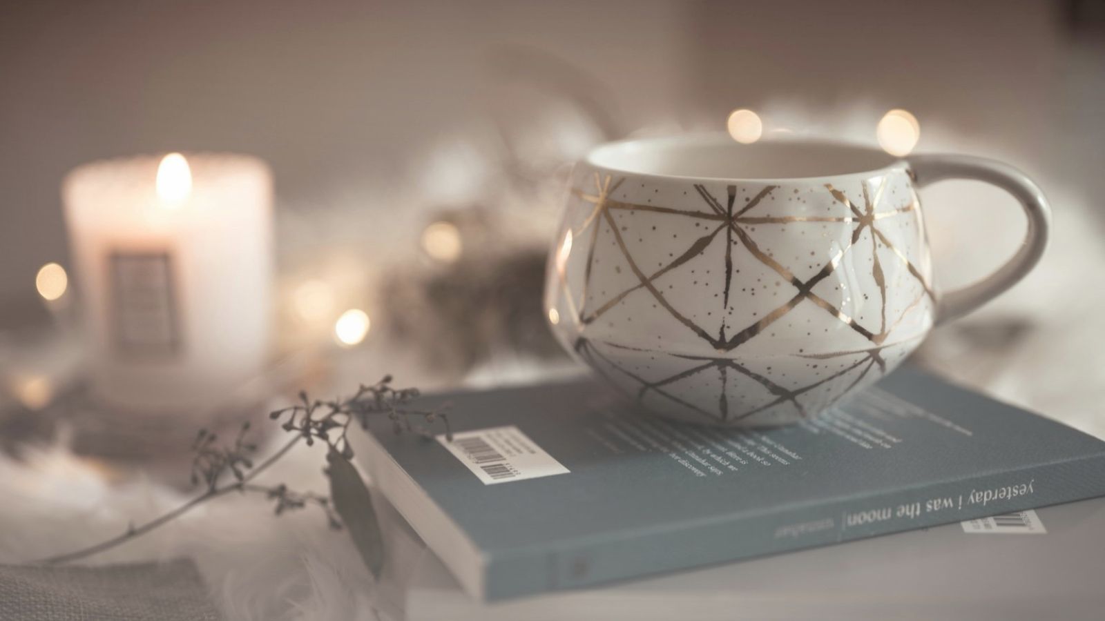Nighttime wind-down ritual for glowing skin — candlelit teacup on books
