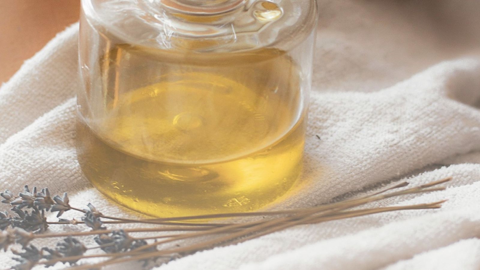 Best glow-boosting face oils post image of oil bottle & dried thyme.