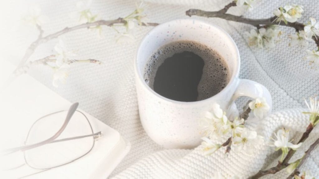 Coffee mug on a white blanket.