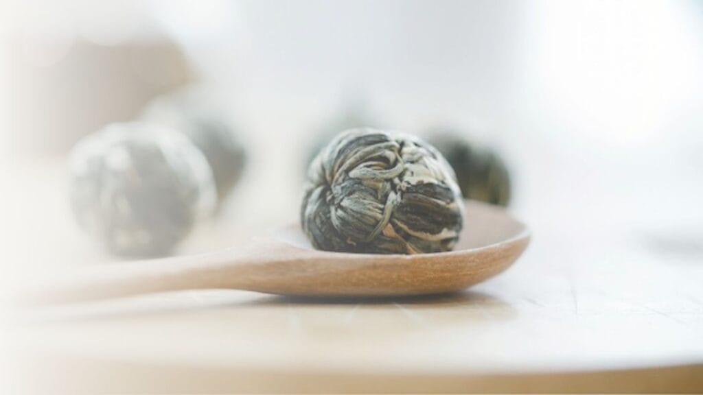 Dried flower on wooden spoon.