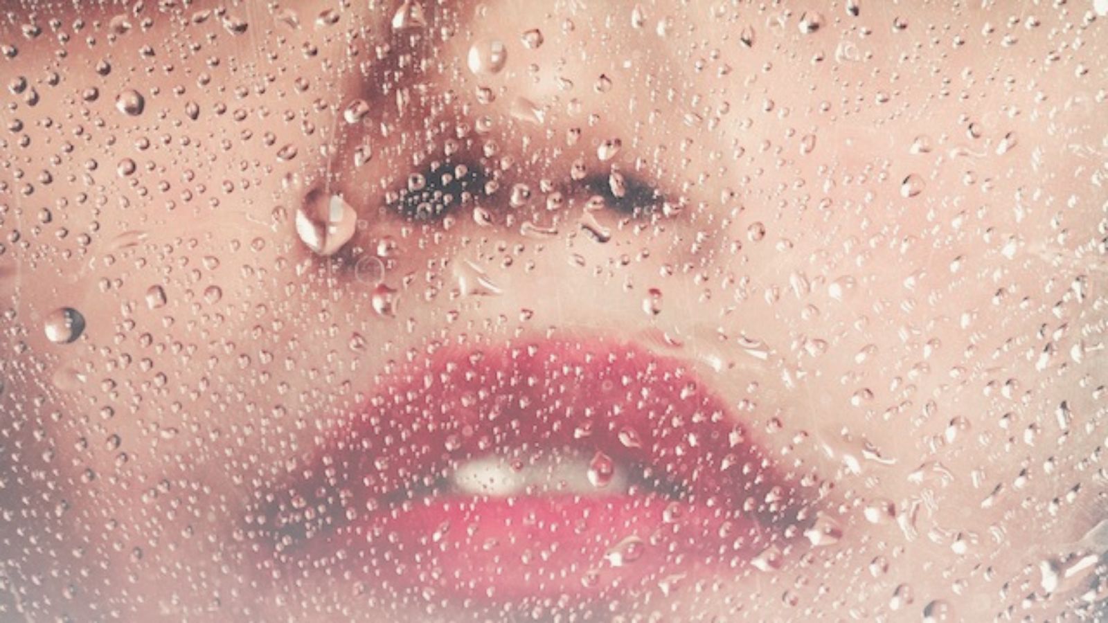 Water droplets and woman's face representing Makeup That Lasts in Humidity Without Looking Heavy.