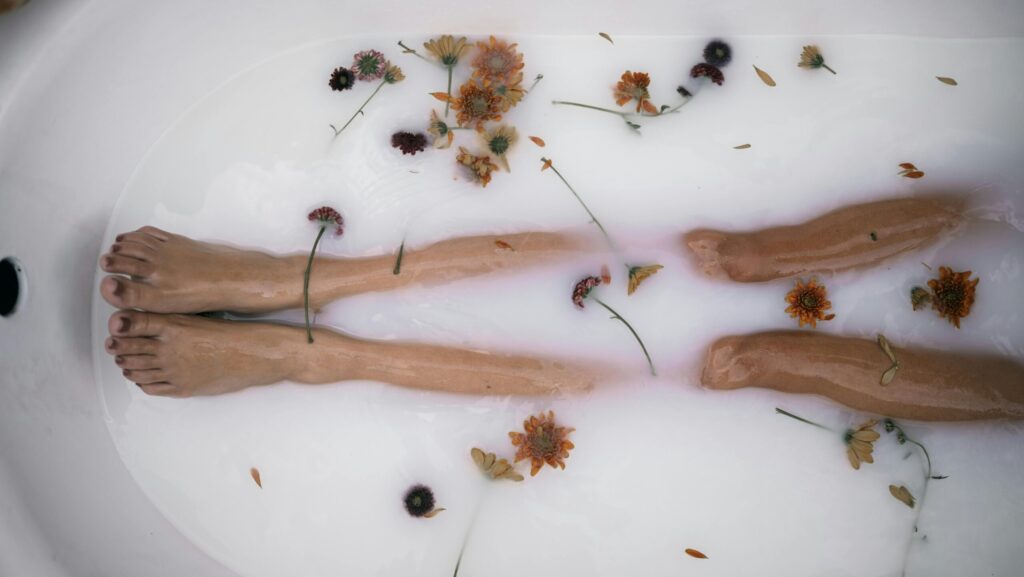 Woman's legs in a milk bath representing best calming skincare for stressed skin