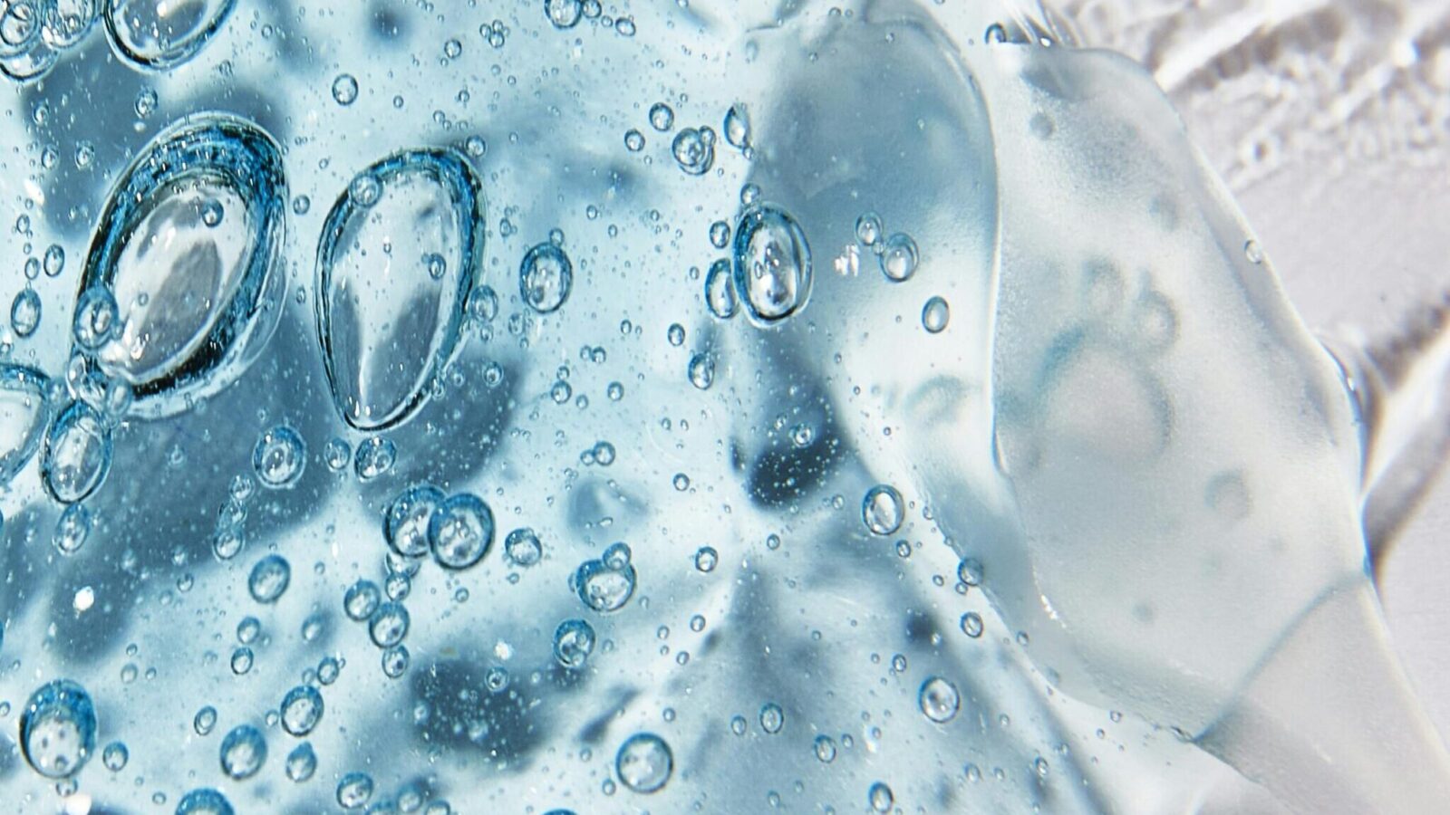 Mixed liquid textures representing how to layer skincare for glowing skin.