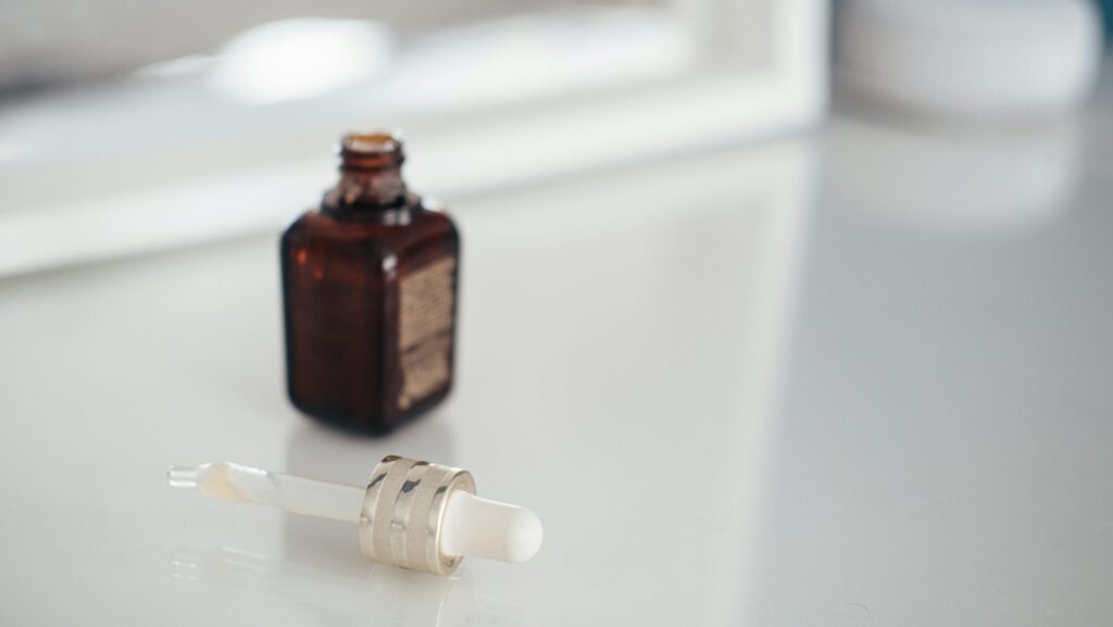 Serum bottle on white clean surface representing the best serums that layer well.