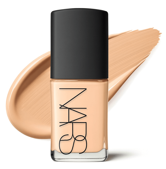 NARS Best Dewy Foundation cream product bottle with a makeup smear behind on white background.