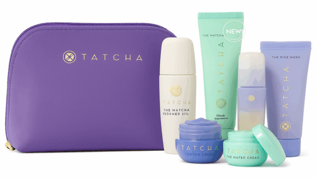 Tatcha six travel-size skincare minis in blue and white packaging, alongside a pouch —luxury skincare gift sets.