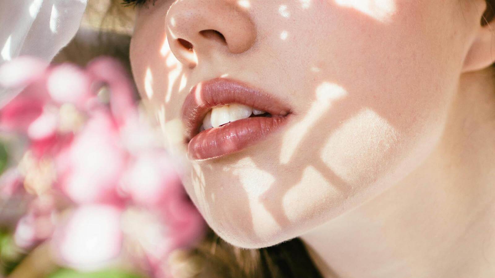 Close up of a woman's cheek with sunlight, illustrating why your cream blush looks patchy and how to fix.